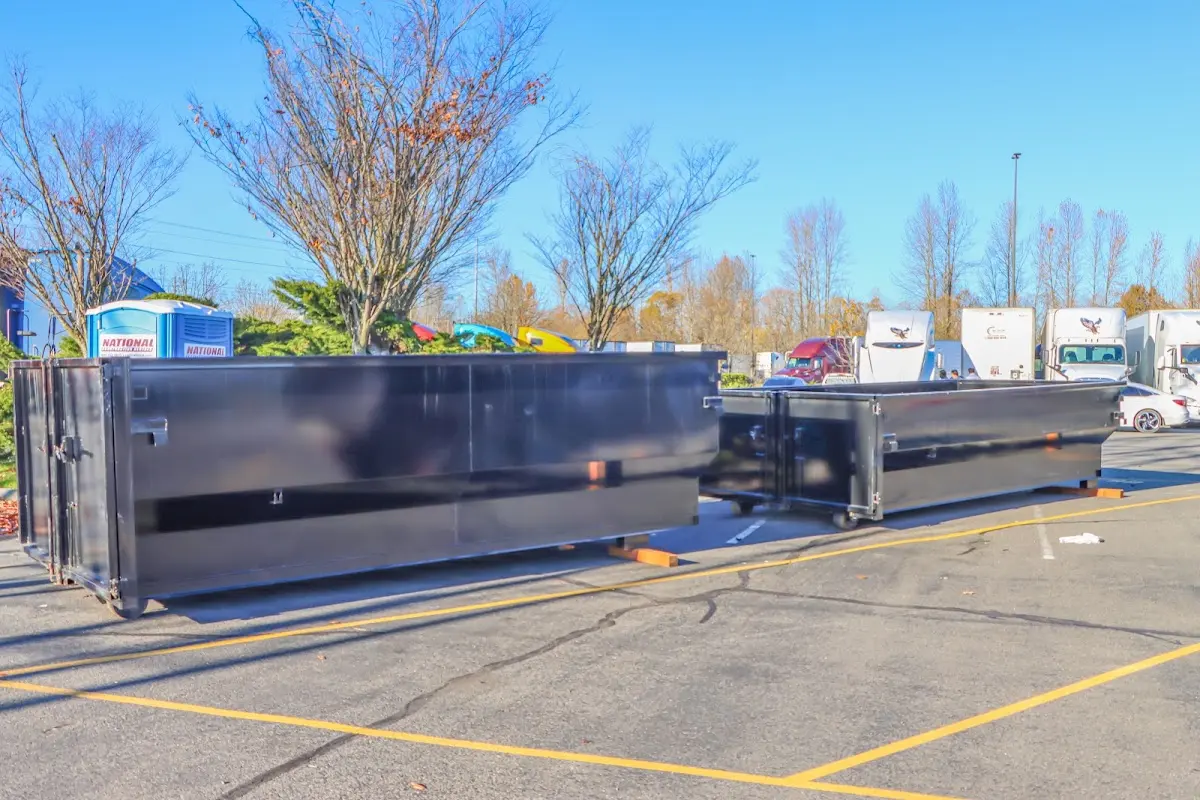 Professional dumpster rental service with roll-off container on residential driveway in Millcreek